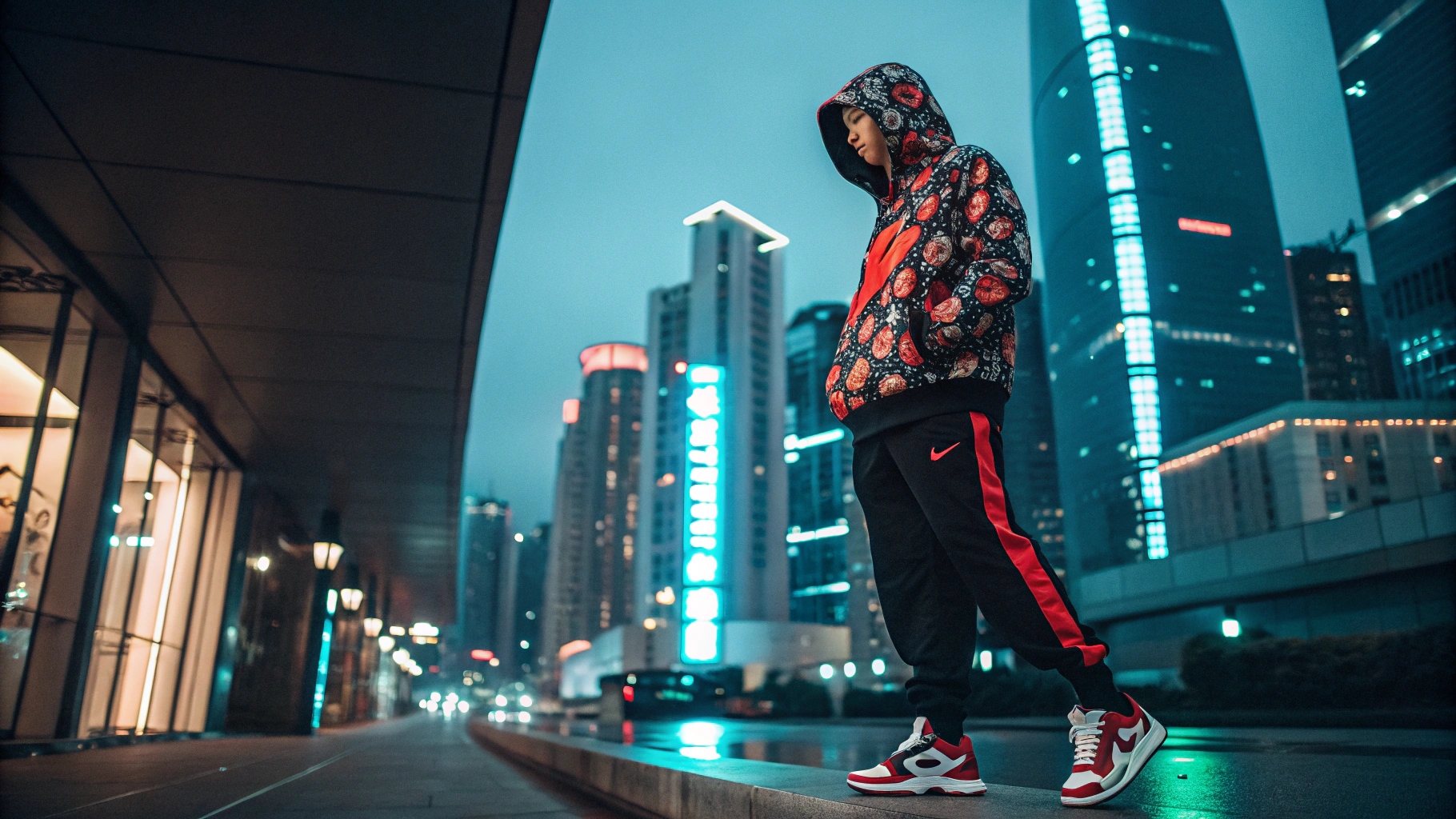 A model wearing a custom-designed Supreme-inspired hoodie with bold graphics and an oversized fit, paired with baggy cargo pants and limited-edition sneakers, set in a modern cityscape with neon reflections.